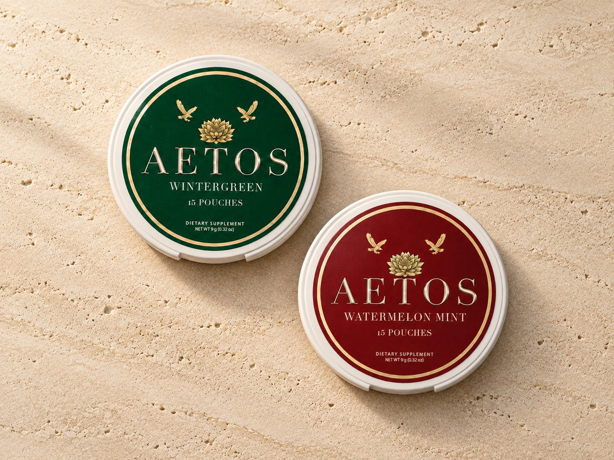 AETOS Wintergreen and Watermelon Mint cans on travertine